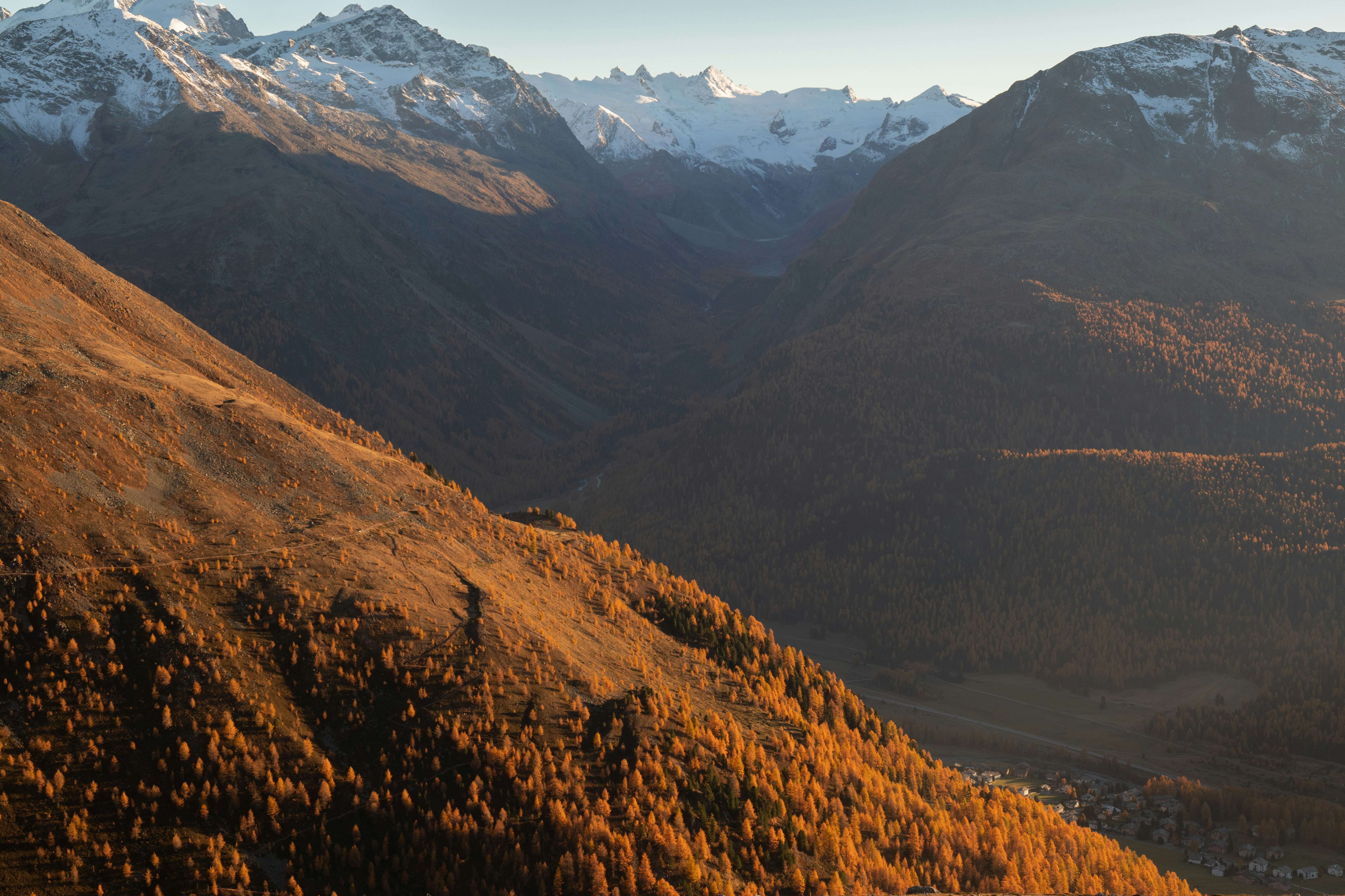 brown and green mountains near lake during daytime